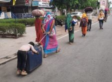 migrant-mother-boy-clinging-on-suitcase India